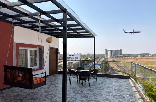 Devanahalli Apartment | Runway Retreat Rooftop Swing, Airport View