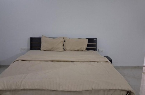 Sanwer Apartment | Spacious bedroom with a patio attached