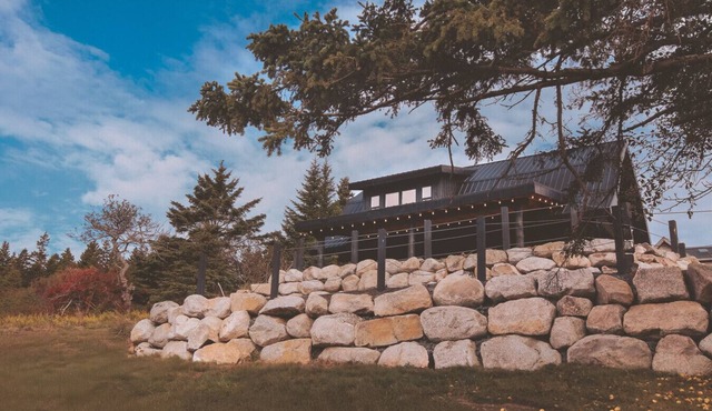 A reconstructed German LogHaus and sanctuary of unmediated coastal observation. in Riverport
