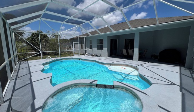 Modern and spacious getaway with a pool and grill in Cocoa