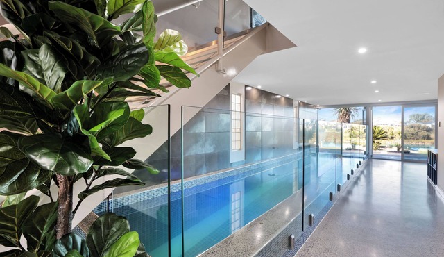 Modern waterfront retreat, with indoor heated pool and games room.