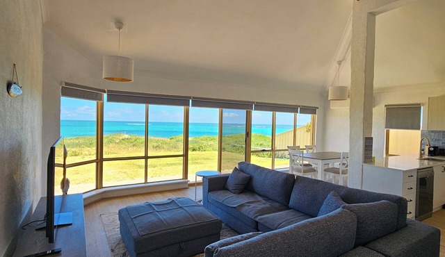 Oceanfront retreat with breathtaking views steps from the shore.