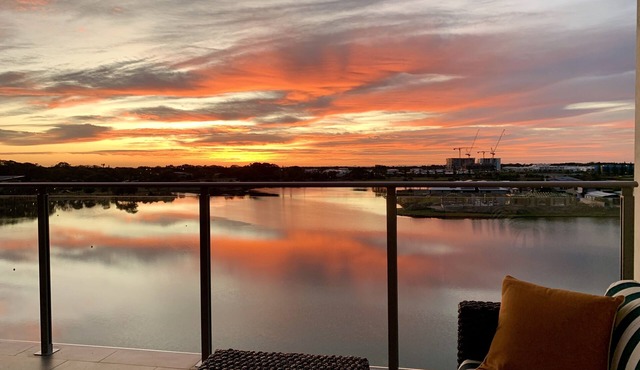 Serene coastal waterfront apartment, private oasis, daily sunrises over ocean.