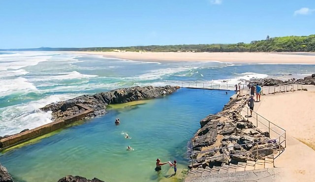 Step out onto the sunny balcony of Peninsula - a spacious beachside home with superb ocean views.