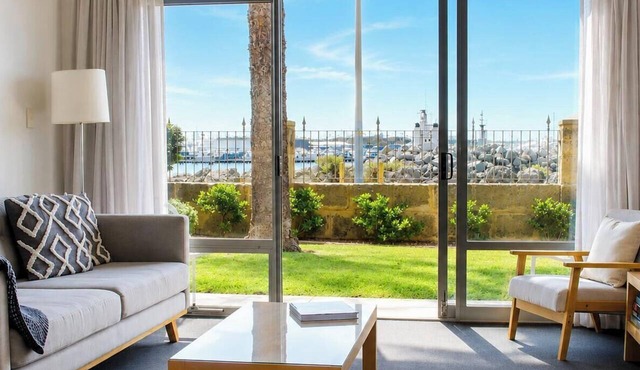 Wake up to sweeping harbour views in this modern, split-level apartment located between Fishing Boat Harbour and Challenger Harbour. Whether you're a couple, a family, or here on business, this peaceful retreat offers the best of coastal charm and ci